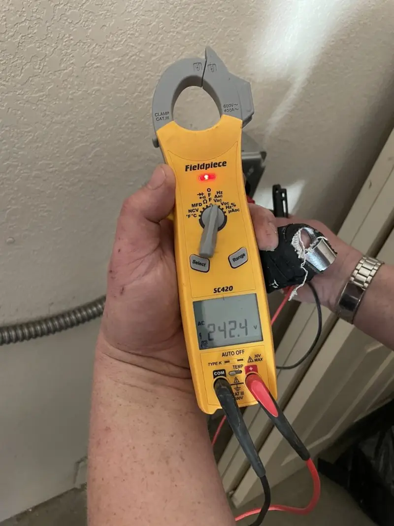 Voltage testing with clamp meter during Outlet Installation in Muncie
